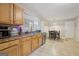 The kitchen features wooden cabinets, stainless steel appliances, and a view of the dining area at 7813 Newbury Dr, Jonesboro, GA 30236