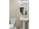 A powder room features a pedestal sink, round mirror, and decorative accents at 7813 Newbury Dr, Jonesboro, GA 30236
