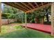 Relaxing backyard with a wood deck, gazebo, privacy fence, and artificial turf at 984 Wenham Ln, Lawrenceville, GA 30044