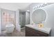 Updated bathroom features soaking tub, glass enclosed shower, modern vanity, and wood-look floors at 984 Wenham Ln, Lawrenceville, GA 30044