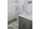 Updated bathroom features a glass enclosed shower, modern vanity, and neutral color palette at 984 Wenham Ln, Lawrenceville, GA 30044