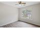 Bedroom showcasing natural light, a ceiling fan, and wood-look laminate flooring at 984 Wenham Ln, Lawrenceville, GA 30044