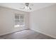 Bedroom showcasing natural light, ceiling fan, and wood-look laminate flooring at 984 Wenham Ln, Lawrenceville, GA 30044