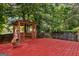 Cozy backyard gazebo retreat on a deck, surrounded by mature trees at 984 Wenham Ln, Lawrenceville, GA 30044