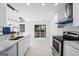 Modern kitchen with stainless steel appliances, white countertops, and access to the backyard at 984 Wenham Ln, Lawrenceville, GA 30044