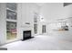 Bright living room features fireplace, large windows, and an open layout to the kitchen at 984 Wenham Ln, Lawrenceville, GA 30044