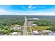 An aerial view shows commercial establishments and roadways, bordered by a lush tree line at 30 Mary Ella Dr, Carrollton, GA 30116