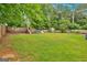 This backyard features a large lawn, playset, storage shed, and a fenced-in yard at 30 Mary Ella Dr, Carrollton, GA 30116