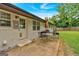 This backyard features a brick patio with an outdoor table, grill, lawn, and a fenced-in yard at 30 Mary Ella Dr, Carrollton, GA 30116