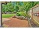 This backyard features a brick patio, flower garden, and a fenced-in yard at 30 Mary Ella Dr, Carrollton, GA 30116