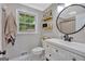This bathroom features a white vanity, framed mirror, and open shelving at 30 Mary Ella Dr, Carrollton, GA 30116