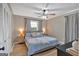 Cozy bedroom with a large window, ceiling fan, and neutral color palette at 30 Mary Ella Dr, Carrollton, GA 30116