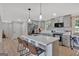 This is a bright kitchen with gray cabinets, stainless steel appliances, and a quartz countertop island with seating at 30 Mary Ella Dr, Carrollton, GA 30116