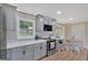 This kitchen features grey cabinets, stainless steel appliances, a breakfast nook, and a window with a backyard view at 30 Mary Ella Dr, Carrollton, GA 30116