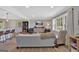 Bright living room with modern decor, hardwood floors, large windows, open to the kitchen at 30 Mary Ella Dr, Carrollton, GA 30116
