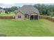 An aerial view of the home showing the backyard and screened-in porch at 108 Donovan Ave, Locust Grove, GA 30248