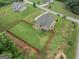 Aerial view of the property featuring a large, well-manicured lawn enclosed by a wood fence and a screened-in back porch at 108 Donovan Ave, Locust Grove, GA 30248