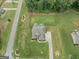 Aerial view showcasing the well-manicured lawn, driveway, and landscaping surrounding this suburban single-Gathering home at 108 Donovan Ave, Locust Grove, GA 30248