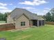 Aerial view of the home showing the screened-in porch, large yard, and privacy fence at 108 Donovan Ave, Locust Grove, GA 30248