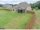 Expansive fenced backyard featuring lush green lawn and a screened in porch, perfect for outdoor entertaining at 108 Donovan Ave, Locust Grove, GA 30248