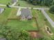 Aerial view of a home featuring a large fenced backyard, manicured lawn, and a screened porch for outdoor relaxation at 108 Donovan Ave, Locust Grove, GA 30248