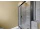 A newly remodeled bathroom featuring a frameless glass shower with gray tile surround and modern fixtures at 108 Donovan Ave, Locust Grove, GA 30248