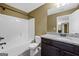 Bathroom featuring granite countertops, white cabinets, tub with shower, and modern fixtures at 108 Donovan Ave, Locust Grove, GA 30248