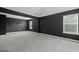 An empty bedroom featuring gray walls, plush carpeting, and windows that fill the room with light at 108 Donovan Ave, Locust Grove, GA 30248