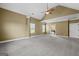 Spacious main bedroom featuring vaulted ceilings, neutral walls, plush carpet, and en suite bathroom access at 108 Donovan Ave, Locust Grove, GA 30248