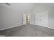 A bright, airy bedroom with high ceilings, neutral tones, plush carpeting, and doors to closet at 108 Donovan Ave, Locust Grove, GA 30248