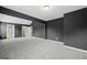 A neutral-colored bedroom featuring carpeted floors, recessed lighting, and an entrance to a walk-in closet at 108 Donovan Ave, Locust Grove, GA 30248