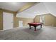 Bonus room showcasing a billiard table, carpeted floors, and natural light from a window at 108 Donovan Ave, Locust Grove, GA 30248