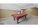 A bonus room that has a billiard table, carpeted floors, and doorways to other rooms at 108 Donovan Ave, Locust Grove, GA 30248