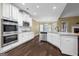 Modern white kitchen with stainless steel appliances, granite countertops, and hardwood floors at 108 Donovan Ave, Locust Grove, GA 30248