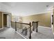 Second floor landing with wrought iron railing overlooking foyer and chandelier below at 108 Donovan Ave, Locust Grove, GA 30248