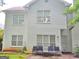 The backyard exterior features a white siding and windows, along with outdoor seating at 3332 Glenrose Trl, Chamblee, GA 30341
