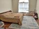 Bedroom with large window, neutral color walls and accents, and a wooden bed frame on a plush area rug at 3332 Glenrose Trl, Chamblee, GA 30341