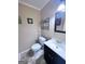 Cozy bathroom featuring dark vanity, modern fixtures, and decor at 796 Glynn Oaks Dr, Clarkston, GA 30021