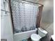 A well lit full bathroom featuring a shower tub with an interesting shower curtain at 796 Glynn Oaks Dr, Clarkston, GA 30021