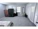 Spacious bedroom with carpet, two windows, a black wardrobe and several storage closets at 796 Glynn Oaks Dr, Clarkston, GA 30021