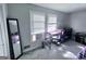 Neutral-toned bedroom filled with furnishings and bright light coming from two adjacent windows at 796 Glynn Oaks Dr, Clarkston, GA 30021