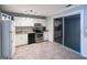 Bright kitchen featuring white cabinets, stainless steel appliances, and sliding glass doors leading to a porch at 796 Glynn Oaks Dr, Clarkston, GA 30021