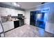 Well-lit kitchen featuring white cabinets, stainless steel appliances, and a sliding glass door at 796 Glynn Oaks Dr, Clarkston, GA 30021