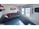 A living room with a grey sofa, decorations, and ample natural light from the adjacent windows at 796 Glynn Oaks Dr, Clarkston, GA 30021