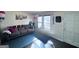 Bright living room featuring a grey sofa, decorations, and an interior door at 796 Glynn Oaks Dr, Clarkston, GA 30021