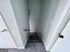 Stairway with carpet that leads downstairs between white walls and wooden doors at 796 Glynn Oaks Dr, Clarkston, GA 30021