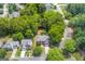 An aerial view shows a charming home nestled among lush trees in a tranquil neighborhood setting at 2600 Neighborhood Walk, Villa Rica, GA 30180
