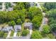 Aerial shot displays the home nestled among lush trees, close to neighborhood streets and other residential properties at 2600 Neighborhood Walk, Villa Rica, GA 30180