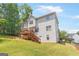 Expansive backyard with deck and stairs leading from this home's back exterior, inviting outdoor enjoyment at 2600 Neighborhood Walk, Villa Rica, GA 30180