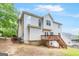 The back exterior boasts a charming deck and stairs, seamlessly blending indoor-outdoor living at 2600 Neighborhood Walk, Villa Rica, GA 30180